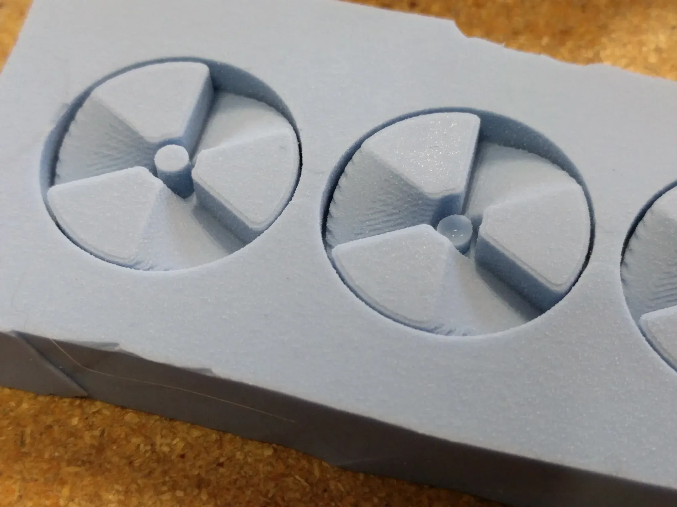 Close-up of silicone Bit Fan mold showing captured detail