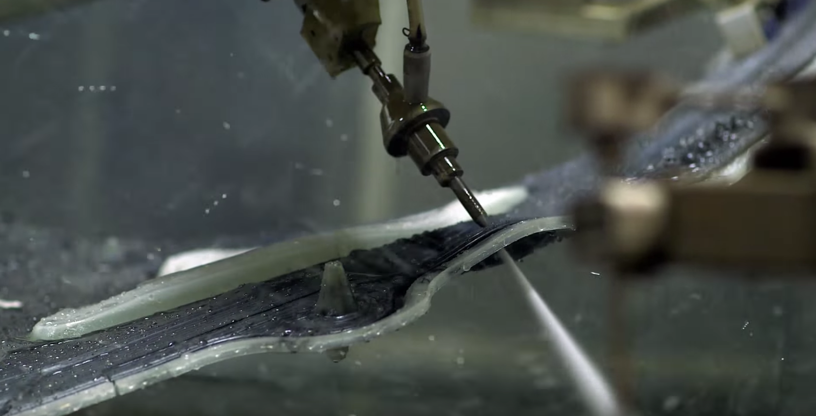 Five-axis waterjet cutting openings in carbon-fiber structure