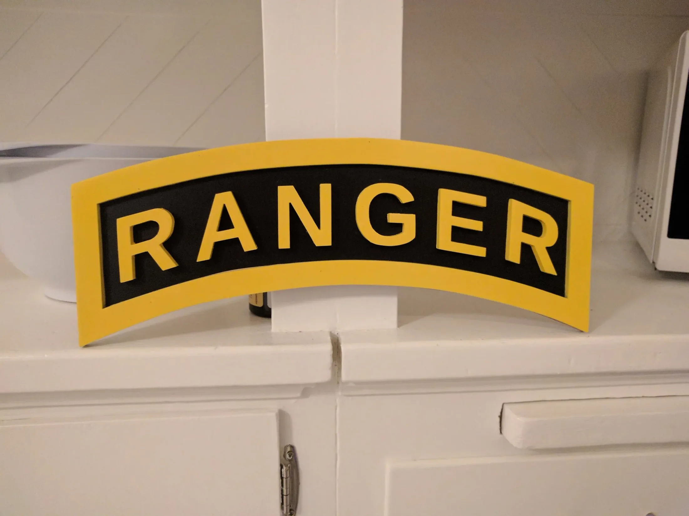 Reference photo of original Ranger Tab insignia