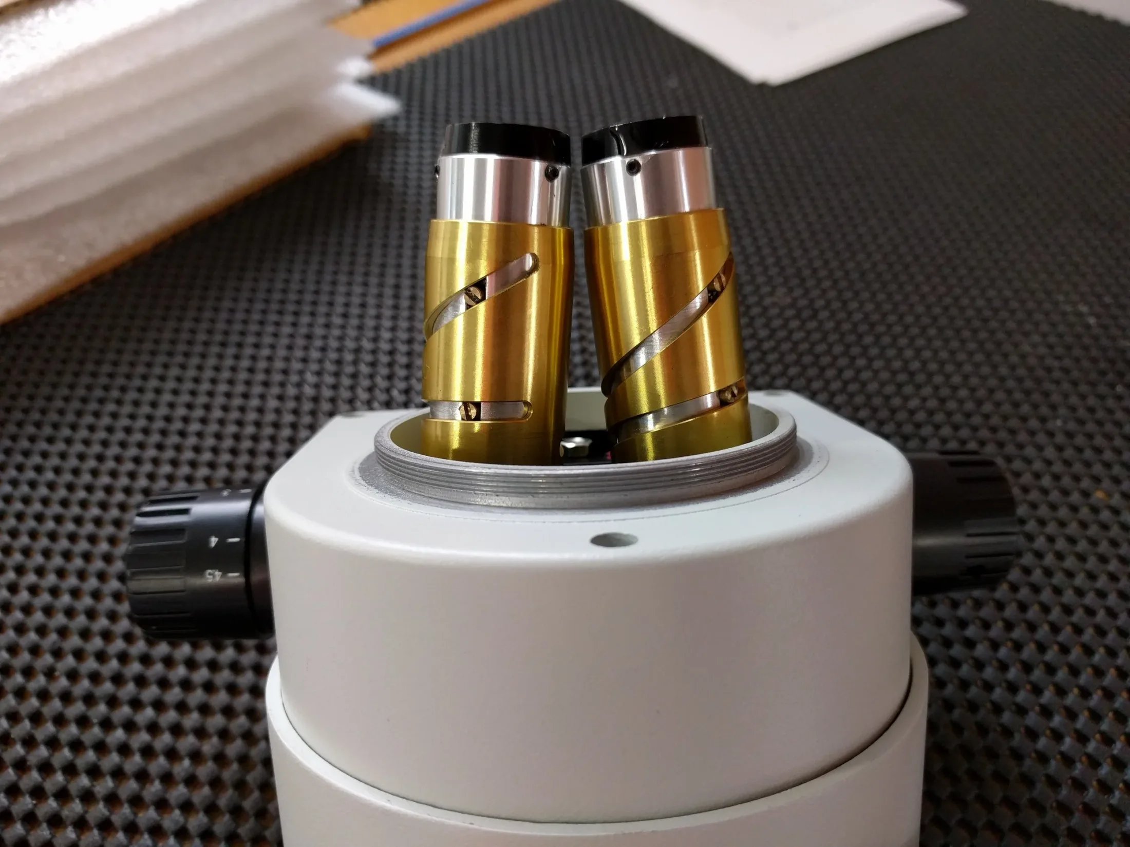 Disassembled microscope zoom assembly with barrel cams exposed