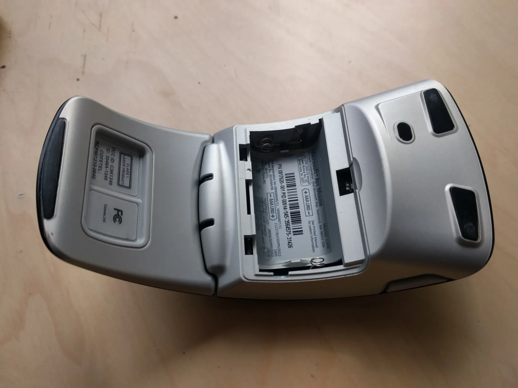 Arc Mouse base with rubber feet removed to expose screws