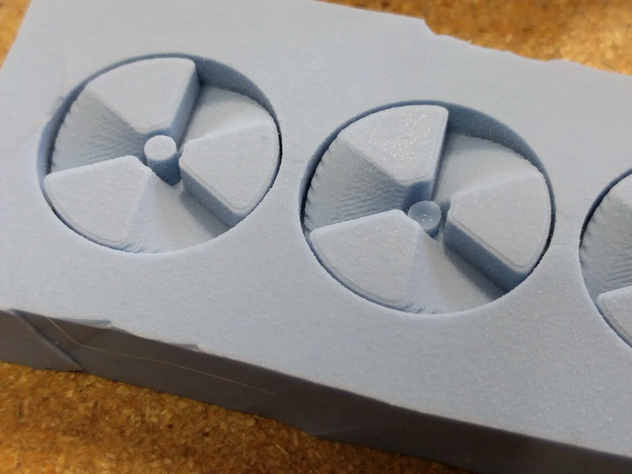 Close-up of silicone Bit Fan mold showing captured detail